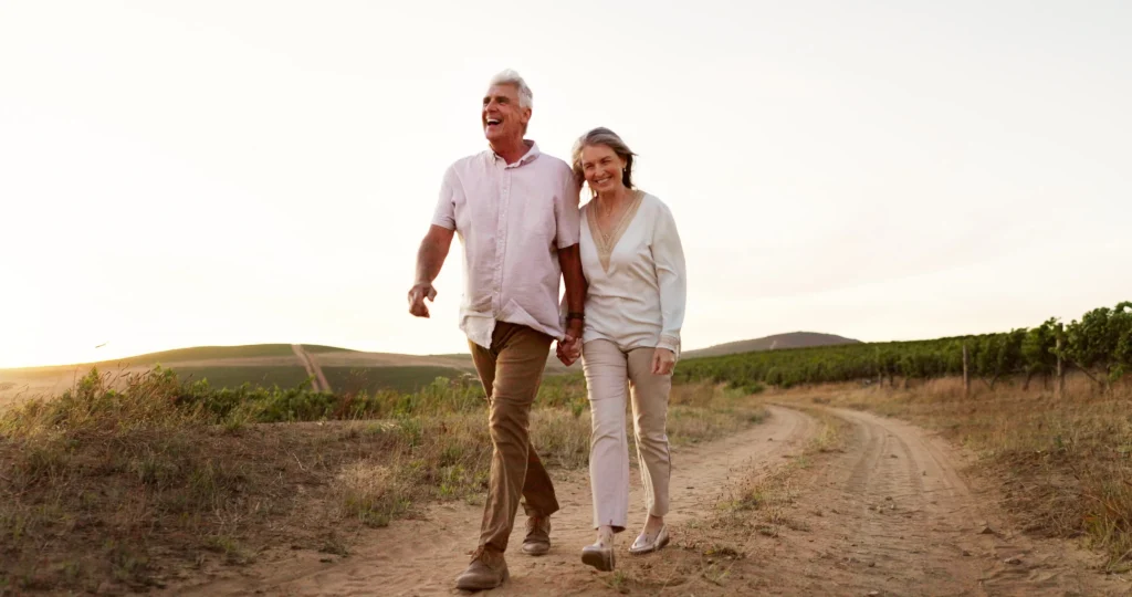 Smiling senior couple walking together outdoors after a Peptide Therapy