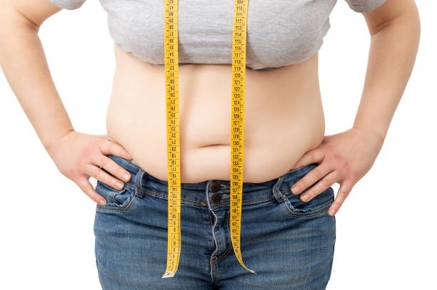 Person measuring waist with tape before diagnosis
